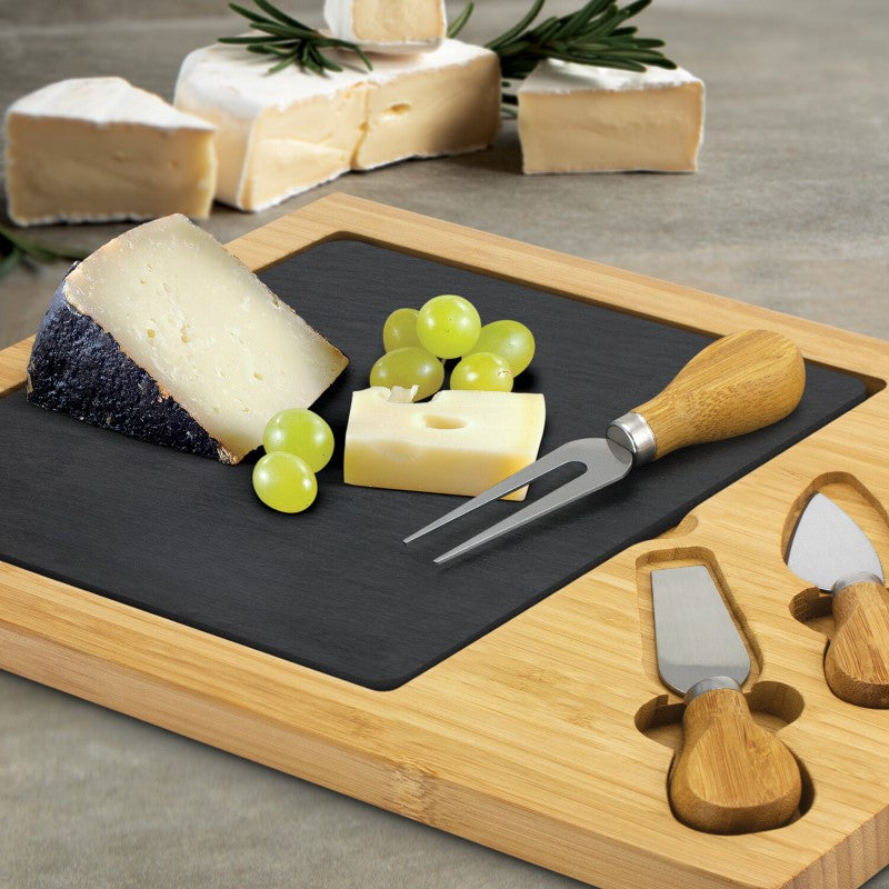 Luxurious slate cheese serving board with knives and fork, perfect for elegant cheese platters and entertaining.