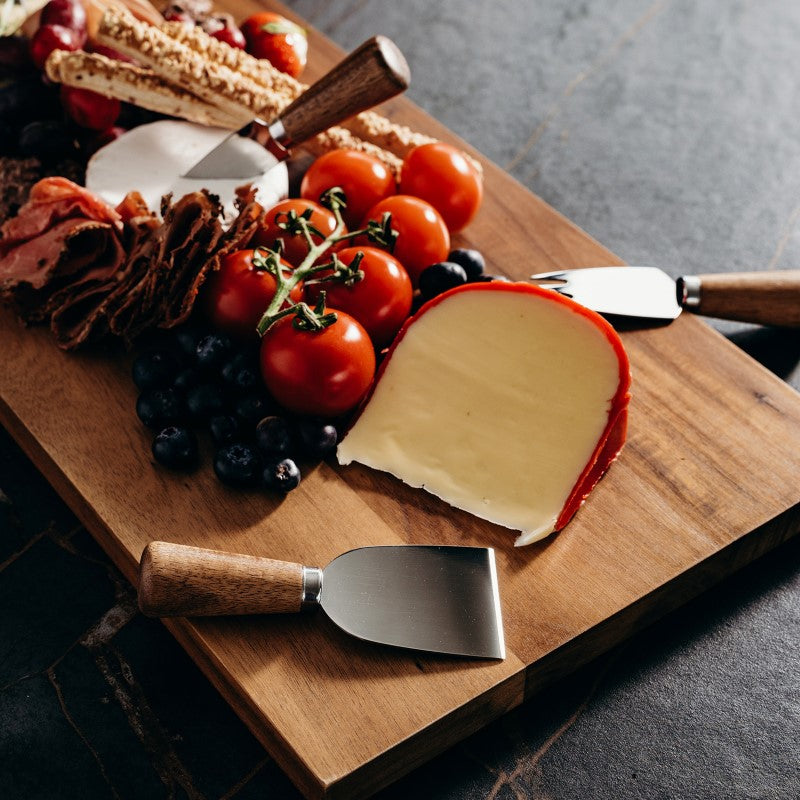 4-piece cheese knife set with Acacia wood handles and stainless steel blades, perfect for slicing, spreading, and crumbling various cheeses.
