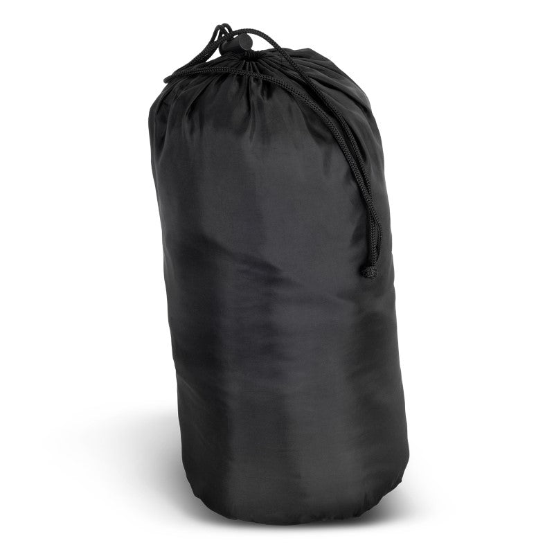 Cozy puffer blanket with stylish design, perfect for indoor/outdoor use, packed in a convenient drawstring pouch.