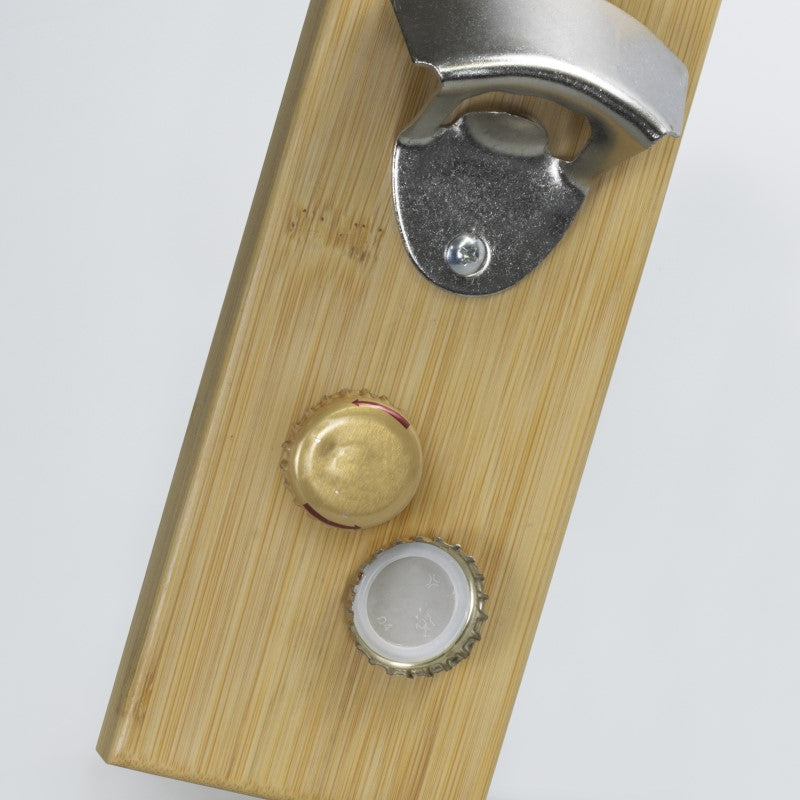 Magnetic bottle opener with cap catcher, bamboo backing, and iron construction; perfect for kitchens and home bars.