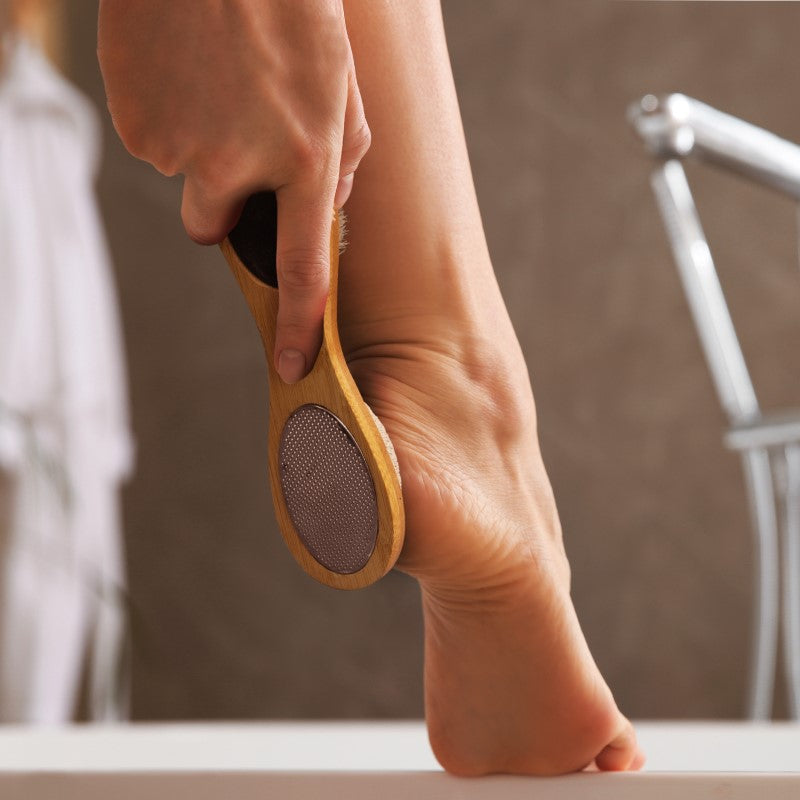 4-in-1 Pedicure Tool with bamboo handle: brush, pumice, nail file, callous remover for smooth, healthy feet.