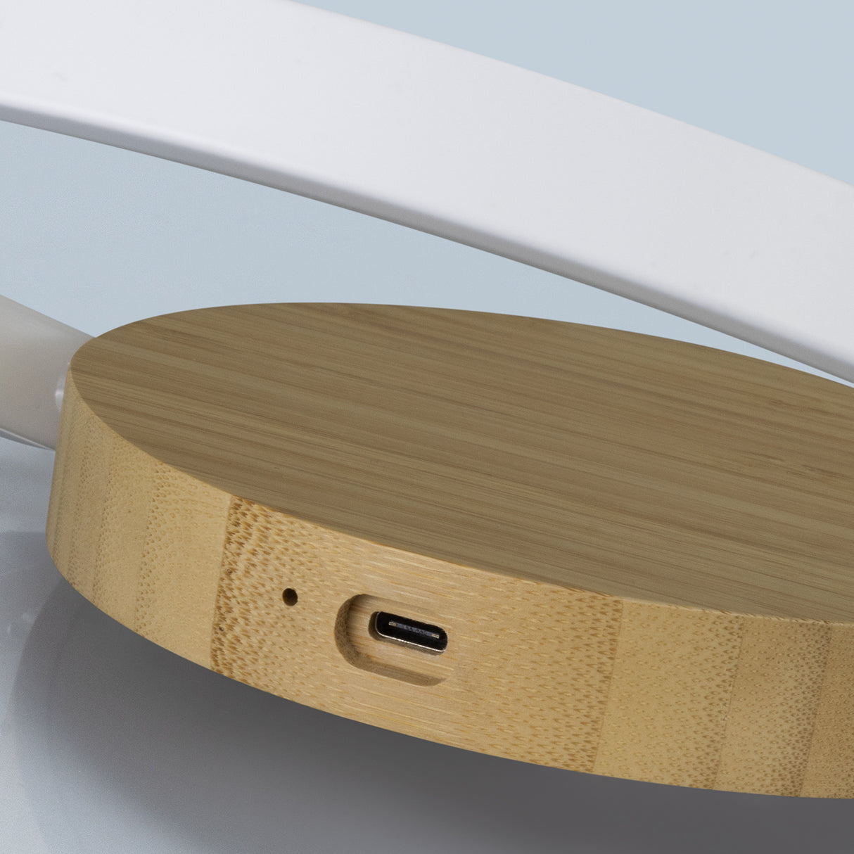 Sleek bamboo night light with wireless charging, touch controls, foldable design, and unique natural grain patterns.