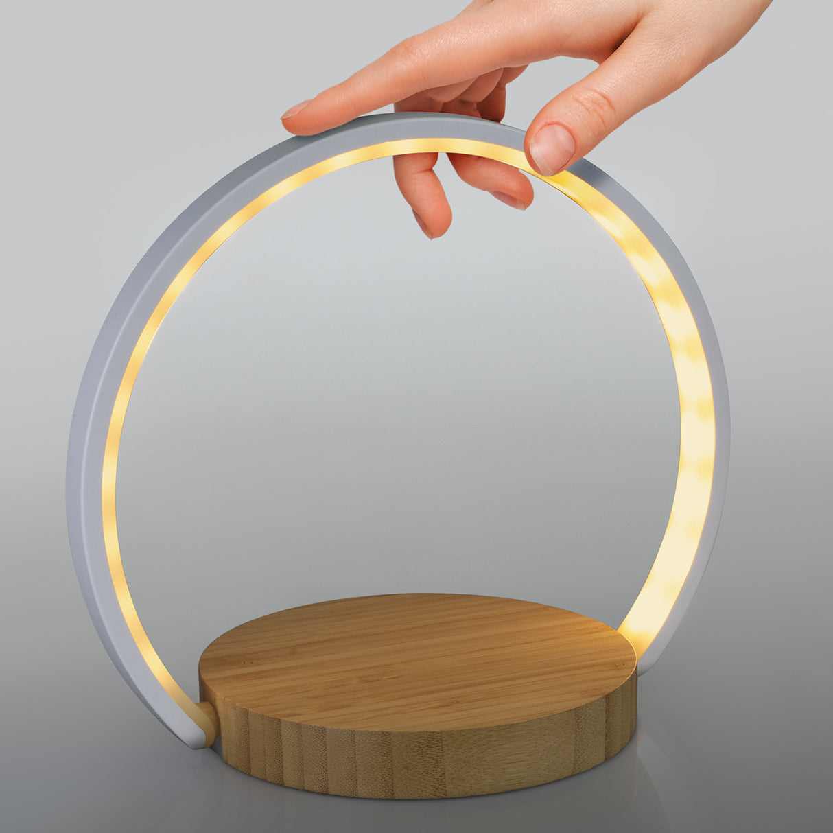 Sleek bamboo night light with wireless charging, touch controls, five brightness settings, and foldable design for easy transport.