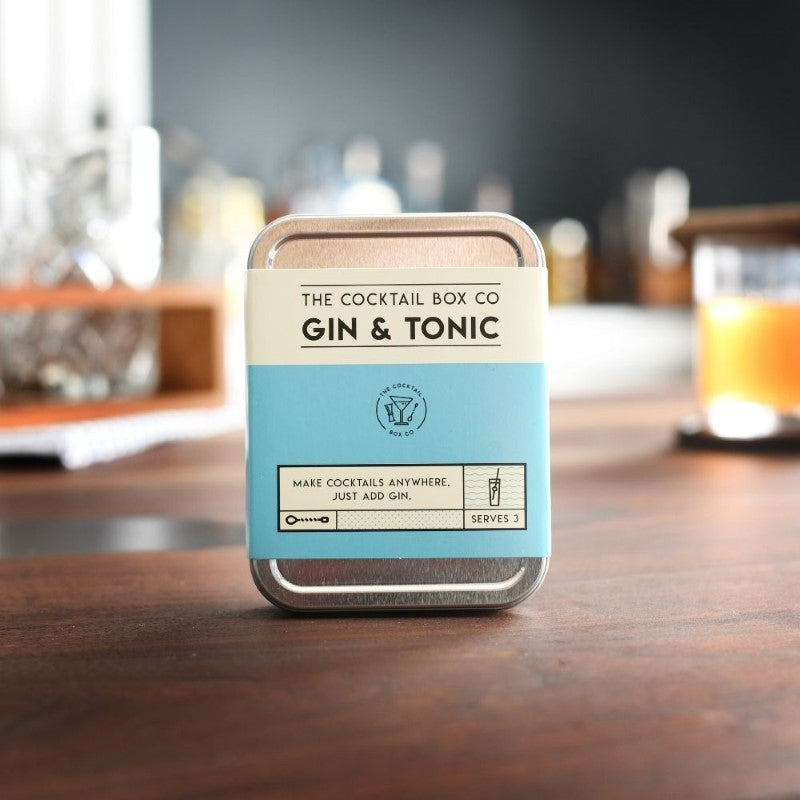 Premium Gin & Tonic Cocktail Kit featuring bitters, tonic syrup, lime juice, tools, and coaster for crafting cocktails anywhere.