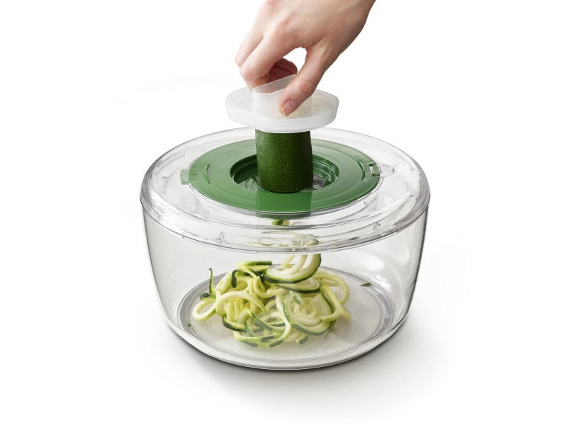 4-in-1 salad bowl set with interchangeable discs for spinning, slicing, grating, and spiralizing; includes finger guard and non-slip base.