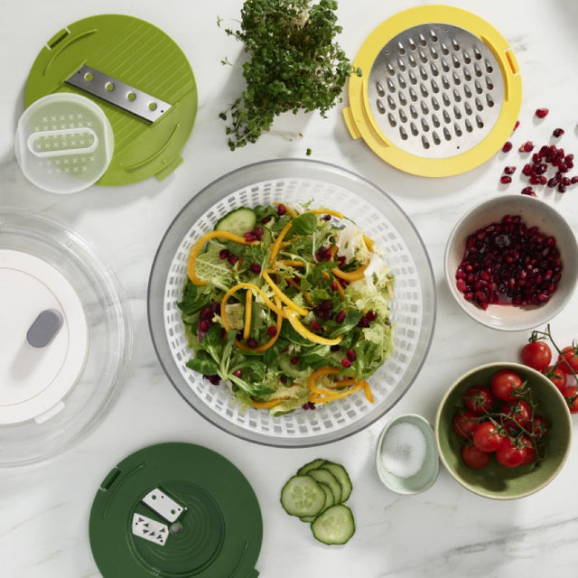4-in-1 salad preparation kit featuring interchangeable discs for spinning, spiralizing, grating, and slicing in a compact design.