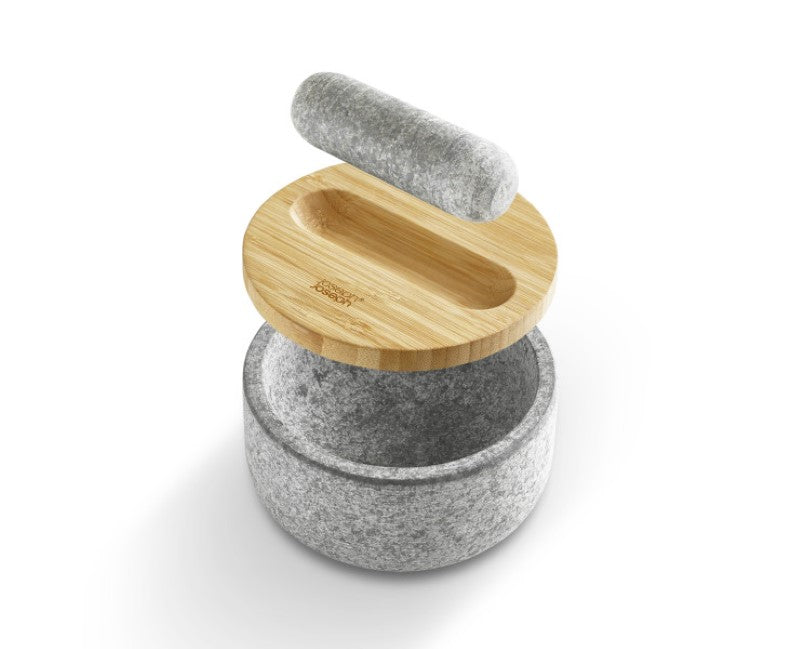 Stylish Joseph Joseph mortar and pestle in natural granite with reversible bamboo lid for versatile ingredient prep and storage.