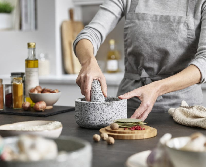 Stylish granite mortar & pestle with reversible bamboo lid for grinding spices and holding ingredients.