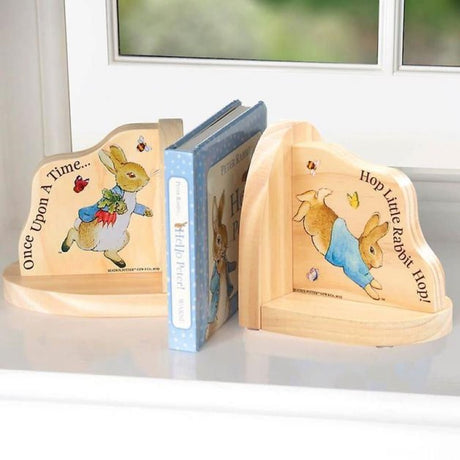 Charming Peter Rabbit wooden bookends with illustrations, perfect for organizing children's books in nursery decor.