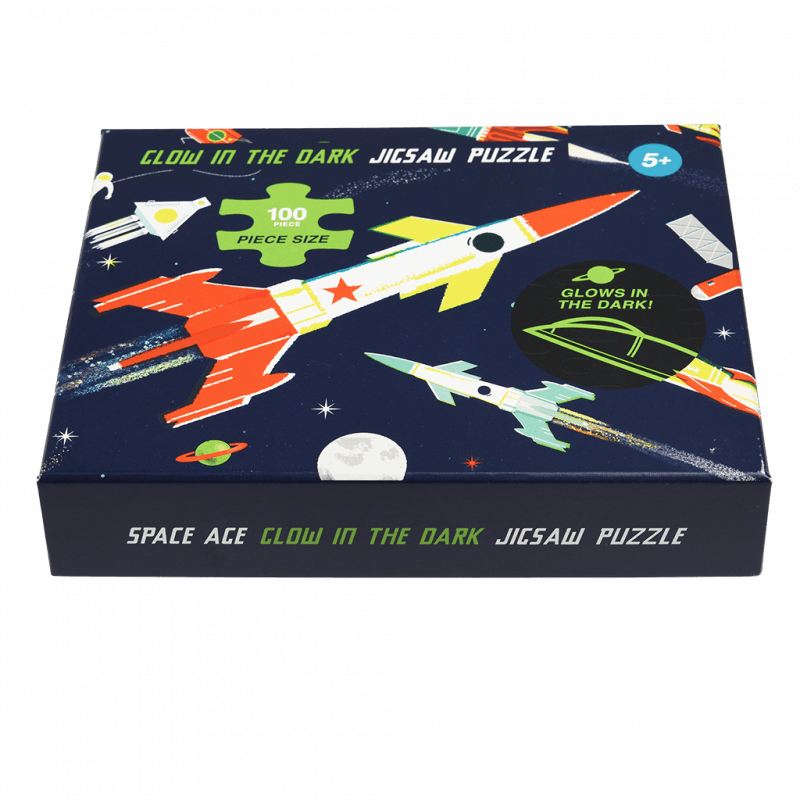 Vibrant Glow In The Dark Space Puzzle with rockets, planets, and stars, perfect for kids aged 5 and up.