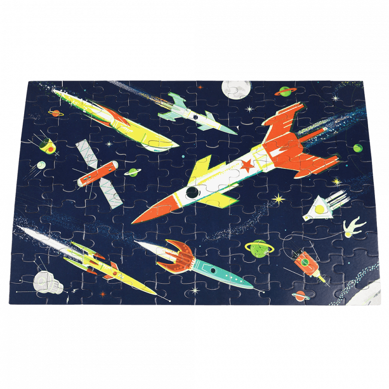 Glow in the Dark Space Puzzle with rockets, planets, and stars, perfect for ages 5+, includes 100 pieces and storage bag.