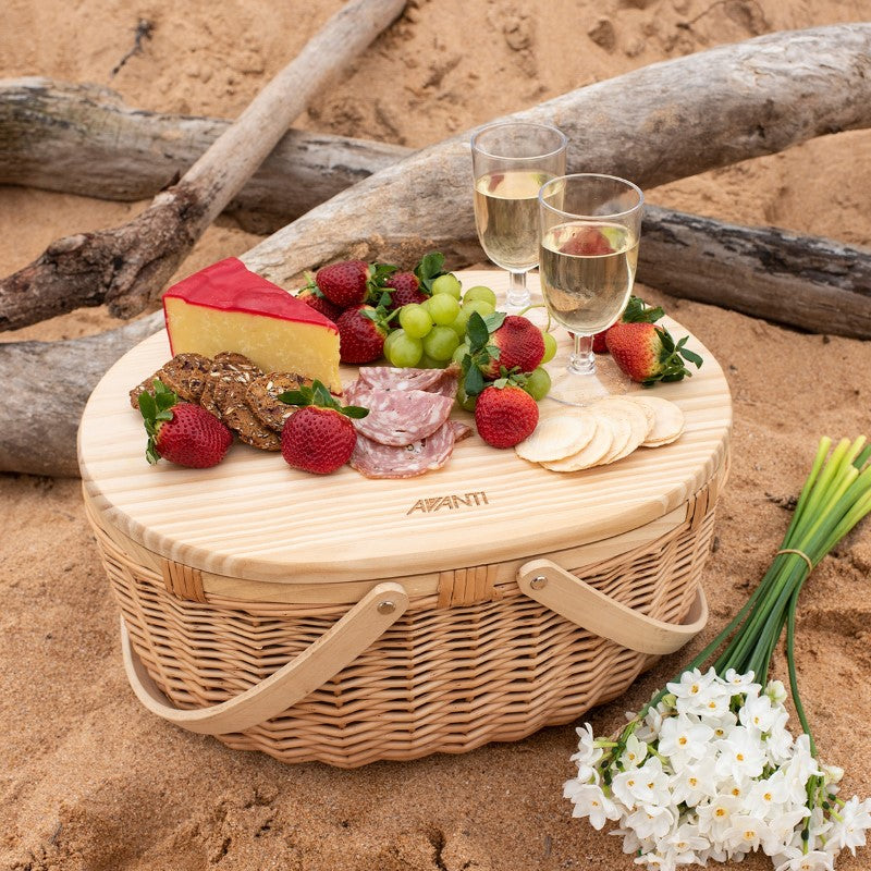 Elegant wicker picnic basket with pine wood lid, insulated interior, and essential dining items for two.