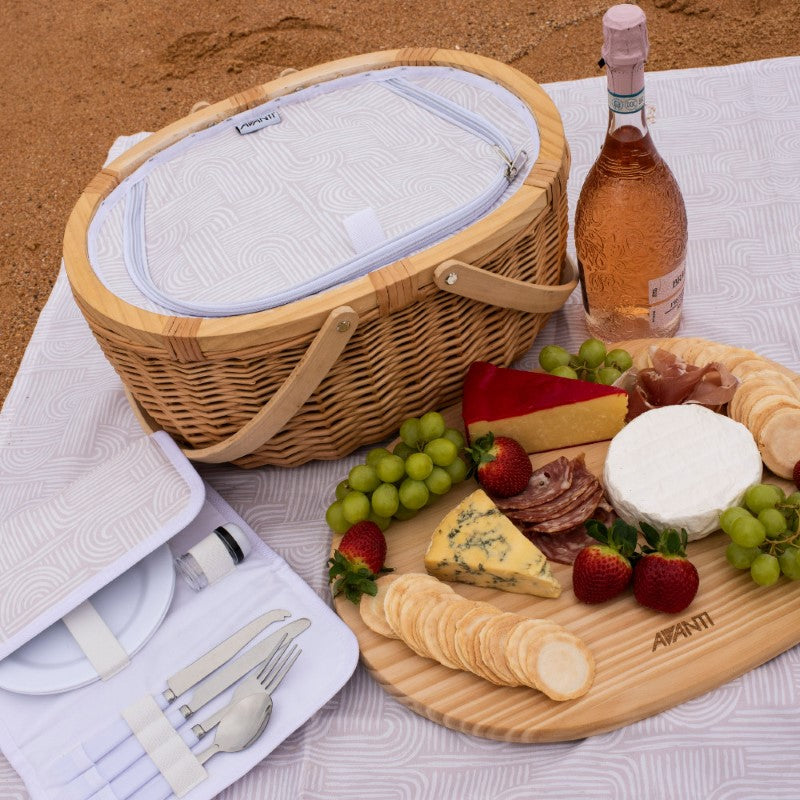 Insulated picnic basket for two with pine wood lid, includes utensils and removable cheese board; perfect for outdoor dining.