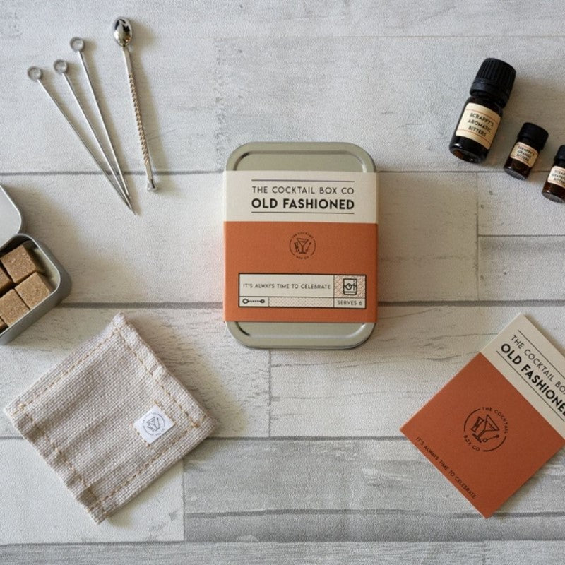 Old Fashioned Cocktail Kit with bitters, sugar, muddler, picks, and napkin for crafting premium cocktails anywhere.