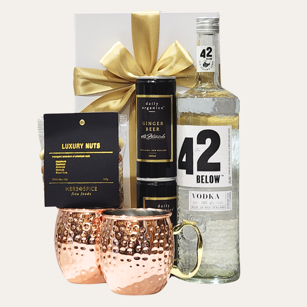 Moscow Mule Kit featuring 42 Below Vodka, two copper mugs, ginger beer, luxury nuts, and a stylish gift box.