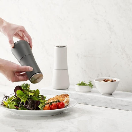 Elegant salt and pepper set with top grinding mechanism to prevent mess and easy size adjustment, ideal for precise seasoning.