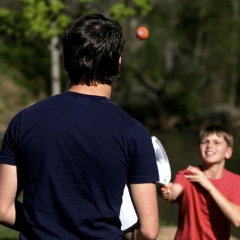 SlingBall Game featuring two rackets and balls for ultimate outdoor catch fun for all ages. Perfect for family gatherings and skill development.