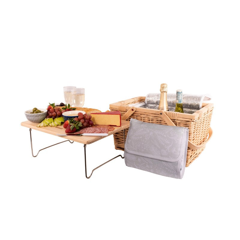 Insulated picnic basket for four with a pine lid that serves as a cheese board; includes utensils and storage for outdoor dining.