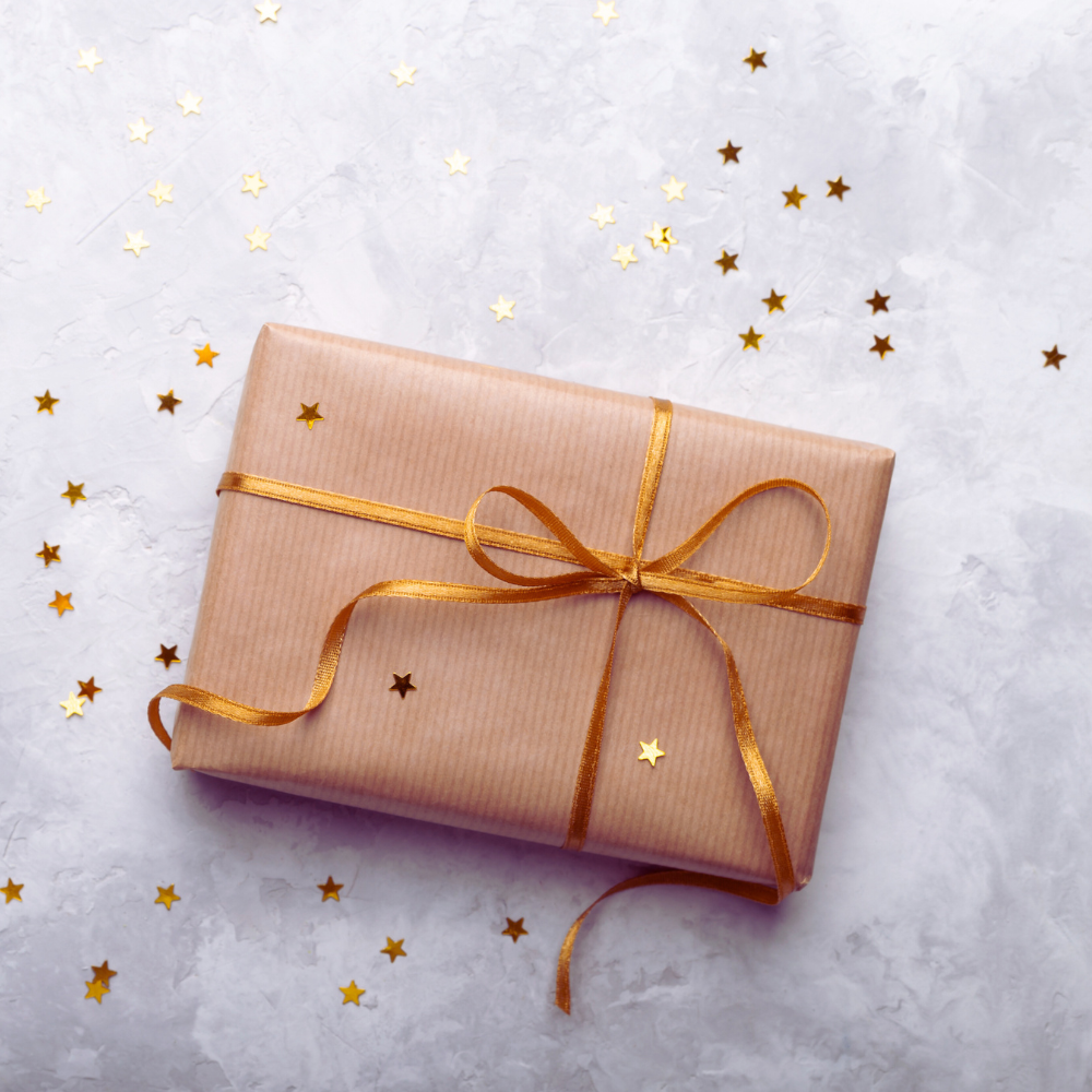 Gift wrapping service with ribbon and a customizable message on a plain white gift card.