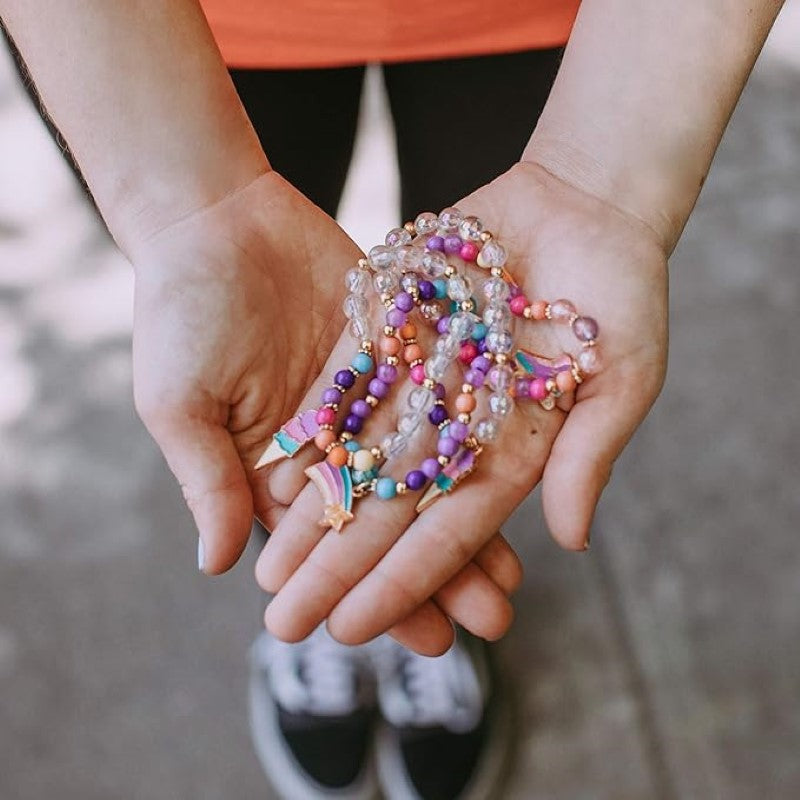 Colorful DIY bracelet and ring kit for girls, featuring beads, charms, and elastic cord for creative jewelry-making.