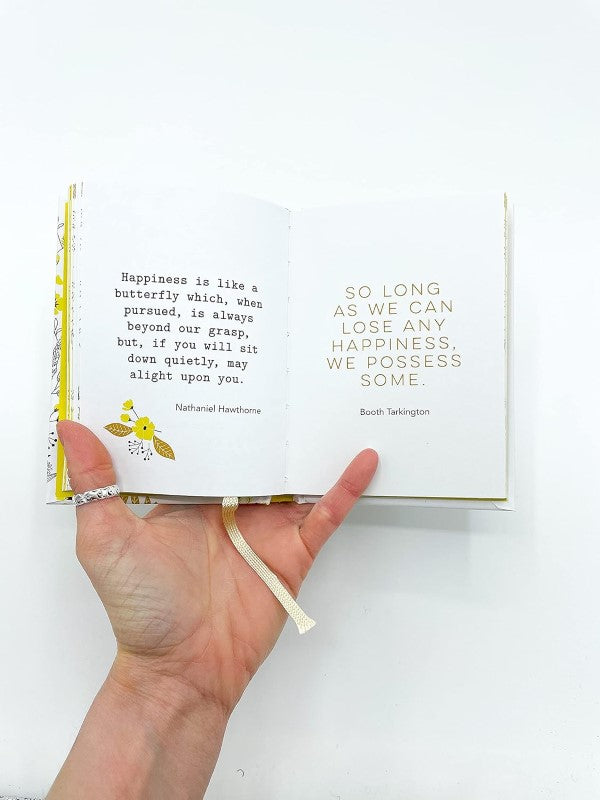 Uplifting pocket-sized book with daily quotes and wisdom from renowned thinkers for inspiration and positivity.