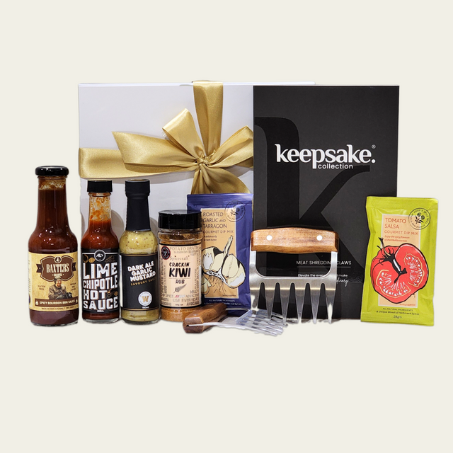 Gourmet BBQ gift box featuring sauces, spices, and meat claws, beautifully packaged for BBQ enthusiasts.