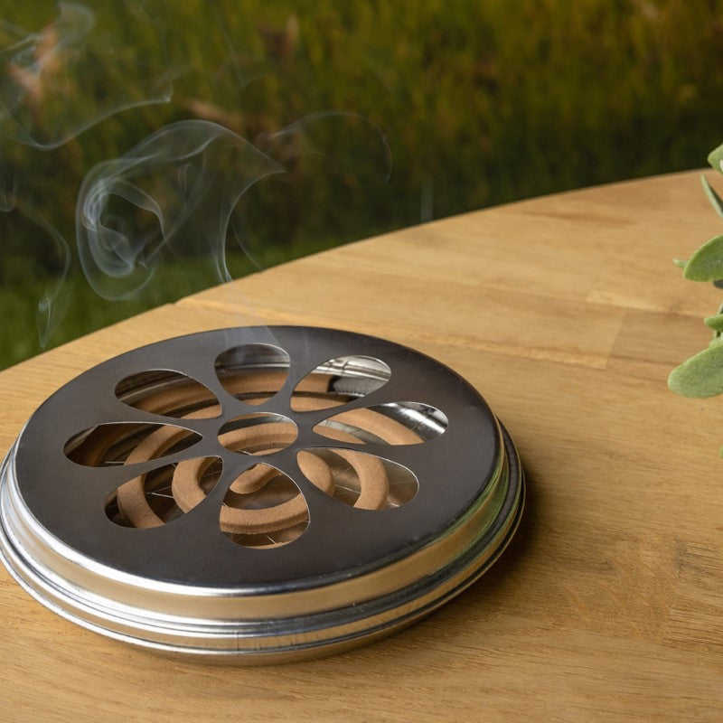 Citronella coils in a zinc burner, designed for effective insect repellent and creating a serene outdoor atmosphere.