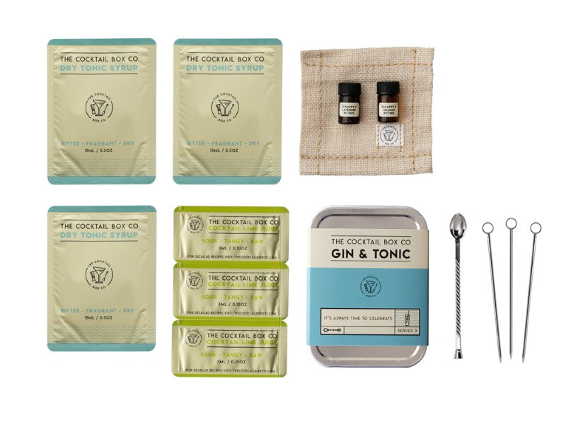 Premium Gin & Tonic Cocktail Kit with bitters, tonic syrup, lime juice, tools, and elegant coaster for sophisticated mixology.
