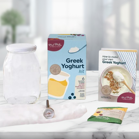 Mad Millie Greek Yoghurt Making Kit with cultures, jar, thermometer, and instructions for homemade yogurt varieties.