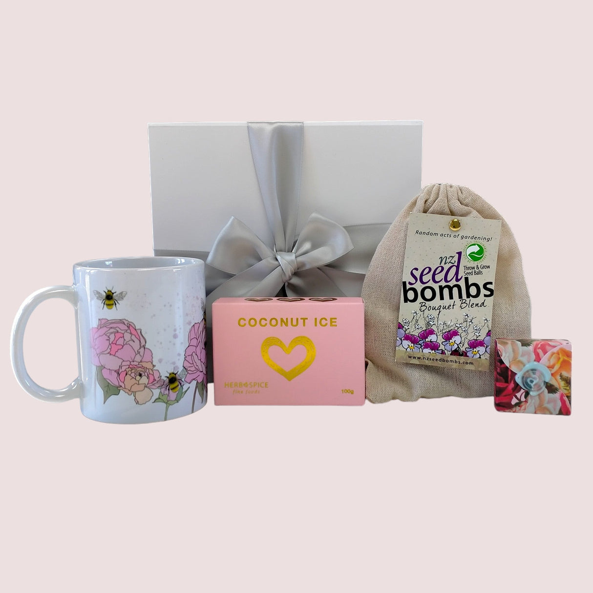 Beautifully curated Lovely Gift Box with a pink peony mug, seed bombs, coconut ice, and lip balm for any occasion.
