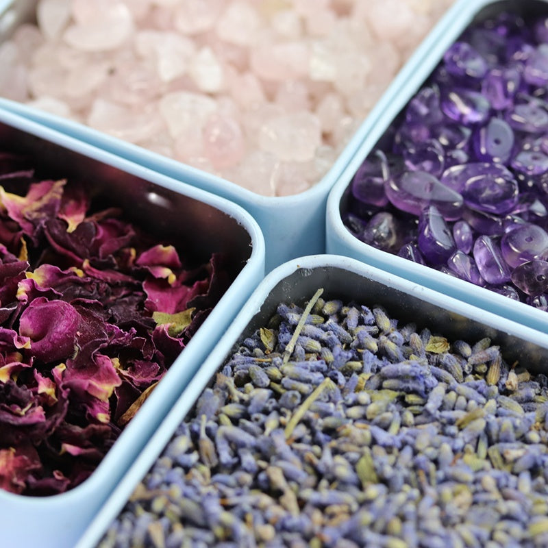 A calming aromatherapy soy candle with essential oils, adorned with crystals and rose petals for relaxation.