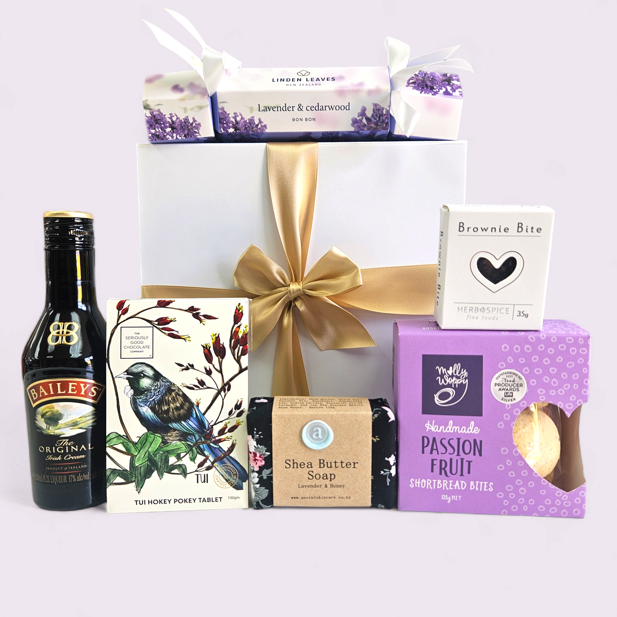 Elegant purple gift box filled with luxurious treats, including Baileys, skincare, shortbread, and handcrafted soap.
