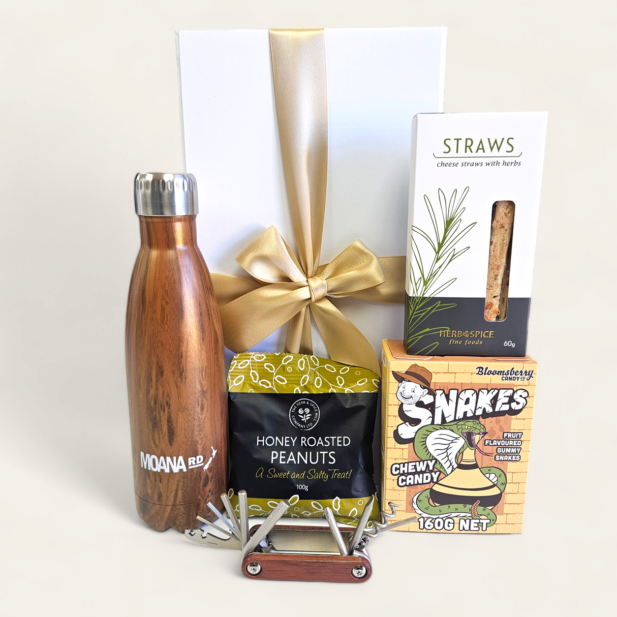 Elegant wooden gift box featuring gourmet treats, practical tools, and stylish Moana Road drink bottle, perfect for any occasion.