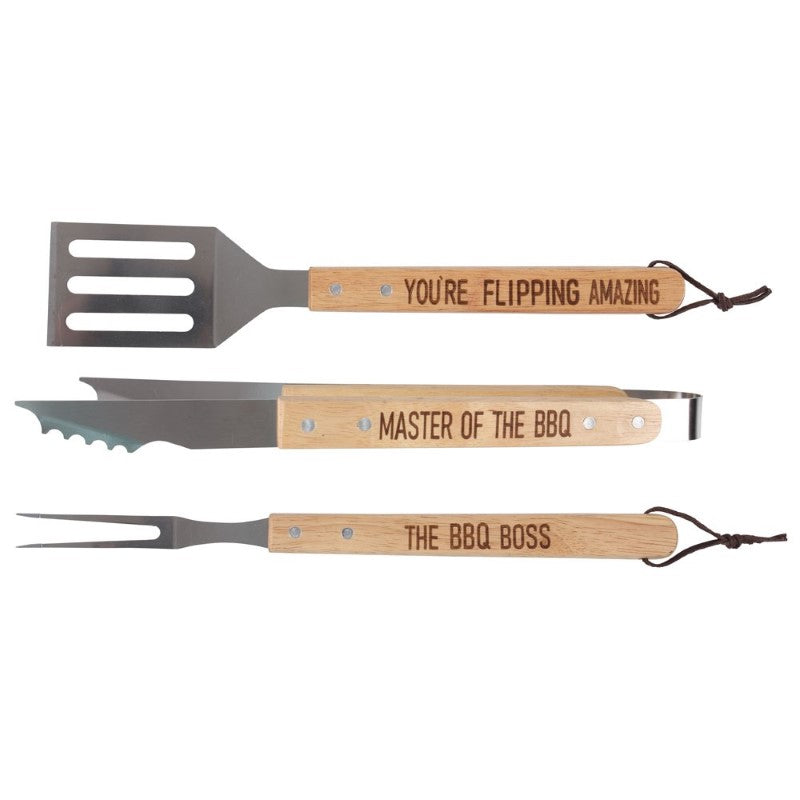 3 Piece BBQ Tool Set featuring stainless steel spatula, fork, and tongs, all with wooden handles and playful text.