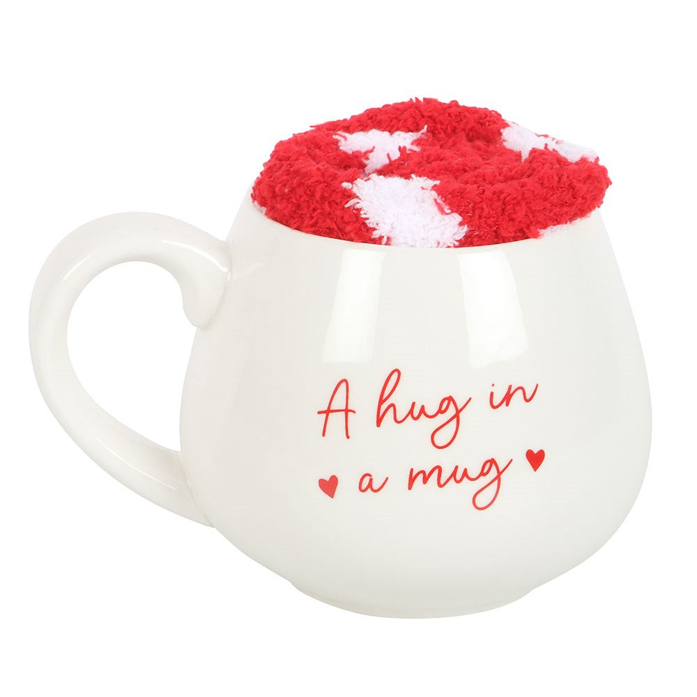 Heart-themed mug and cozy socks set, perfect gift for warmth and comfort in a beautiful packaging.
