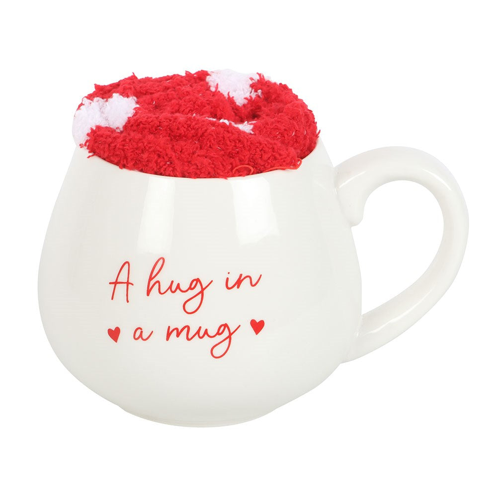 Heart mug and cozy red and white socks set, featuring 'Hug in a Mug' phrase, perfect for warm beverage enjoyment.