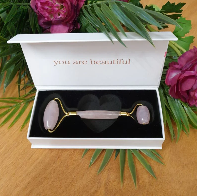 Rose Quartz Crystal Facial Roller with luxurious rose gold handle, two sizes for facial contours, promotes circulation and glow.