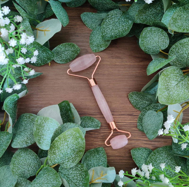 Rose Quartz Crystal Facial Roller featuring two sized rollers for rejuvenating facial care and a luxurious rose gold handle.