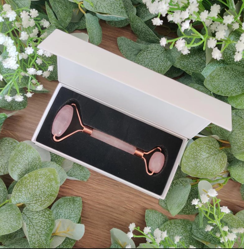 Rose Quartz Crystal Facial Roller with rose gold handle for skincare, featuring large and small rollers for targeted use.