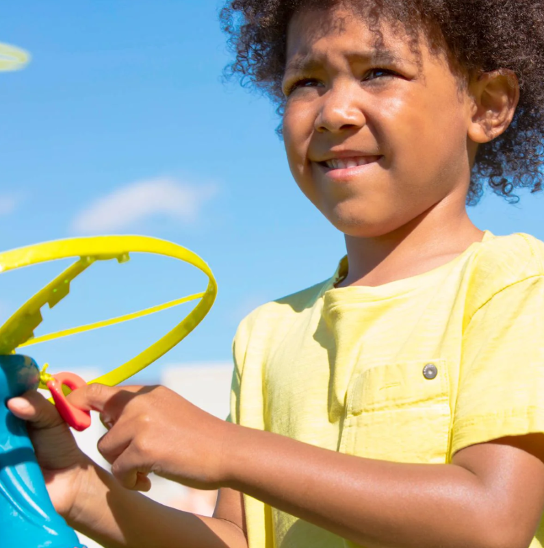Colorful flying disc toy with a light-up feature and ergonomic launcher handle, designed for kids aged 5 and up.