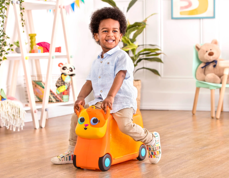 Colorful ride-on suitcase for toddlers, featuring spacious storage, cute fish handle, and fun sound effects for travel adventures.