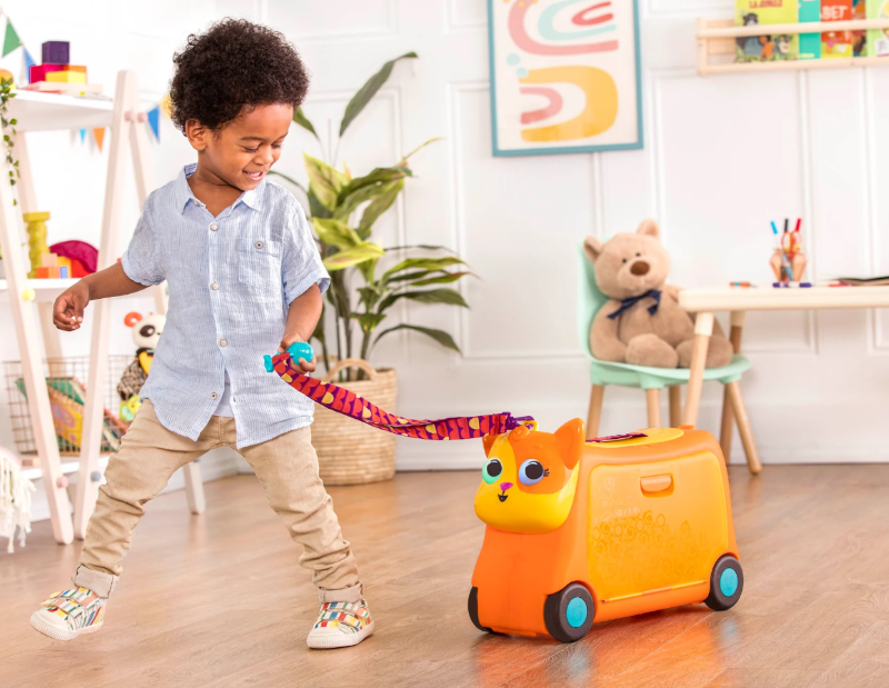 Colorful kids' ride-on suitcase with spacious storage, sound effects, and a cute fish handle for fun travel adventures.