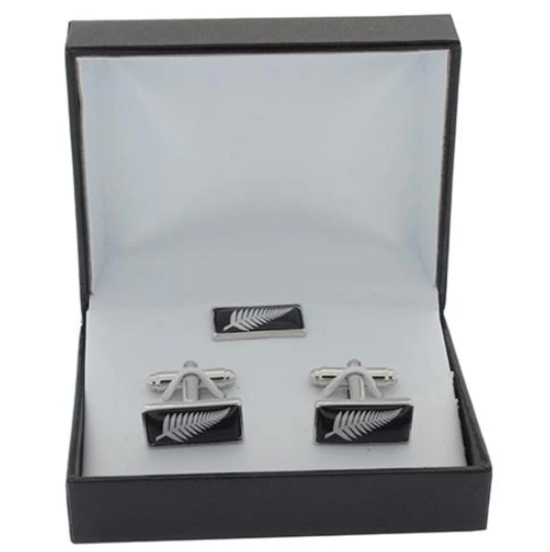 Silver fern cufflinks and lapel pin set, elegantly designed, perfect for formal occasions and celebrating New Zealand heritage.