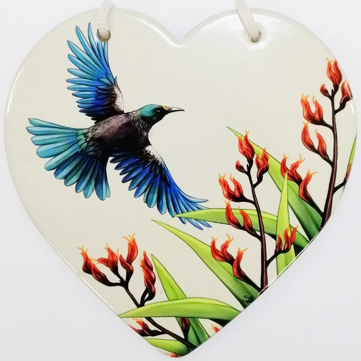 Ceramic heart wall hanging featuring a Tui bird in flight, ideal for home decor and celebrating Kiwi culture.