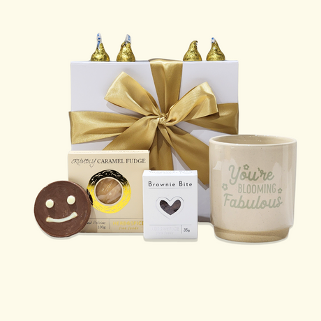 A beautifully packaged gift box featuring a planter pot and assorted delicious treats to brighten someone's day.