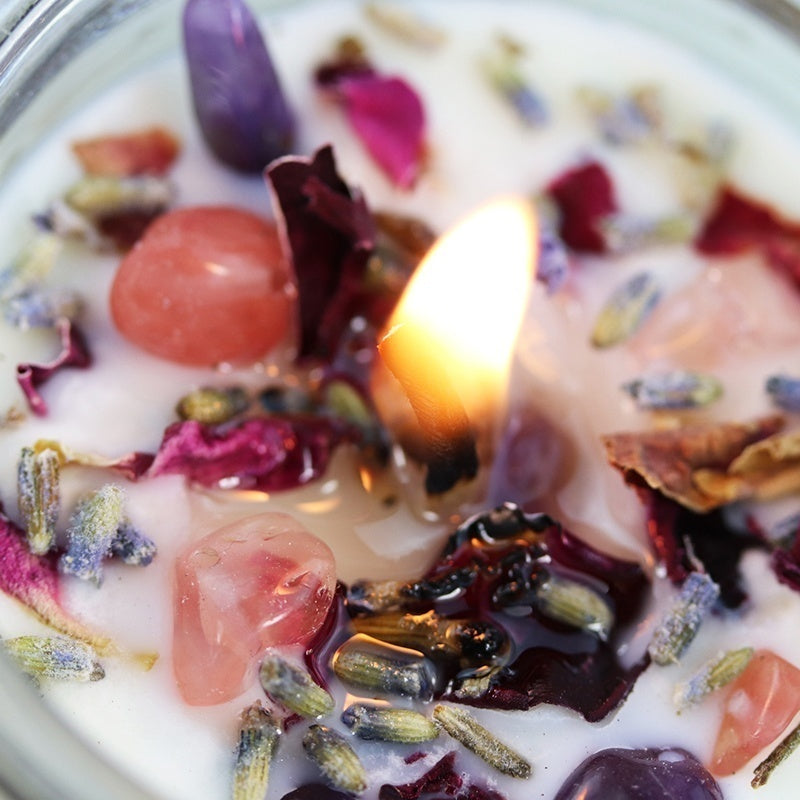 Calming soy candle with essential oils, rose petals, and crystals for relaxation and tranquility, offering a soothing aroma.