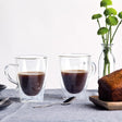 Double wall coffee cup set featuring two elegant 310ml glass cups that keep drinks hot while remaining cool to touch.