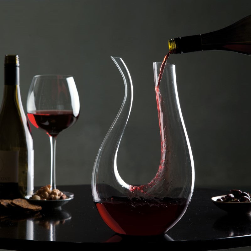 Elegant glass artisan wine decanter with antique brass hardware, designed for optimal aeration and flavor enhancement.