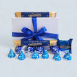 Charming blue gift box filled with Whittaker's milk chocolate, Lindt truffles, Hershey's kisses, and Finn's fudge.