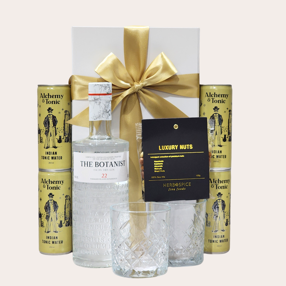Elegant gift box featuring The Botanist gin, glasses, tonic water, and gourmet snacks for the perfect gin & tonic experience.